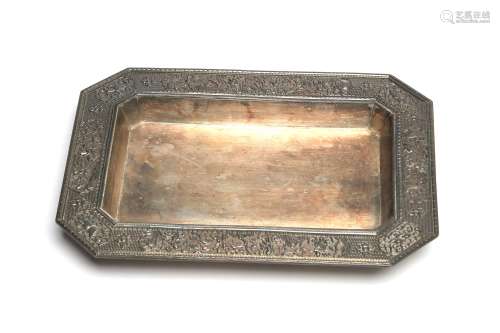 A carved and repousse' silver tray decorated in relief ...