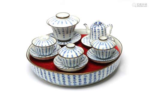 A blue and white porcelain tea set painted with Chinese char...