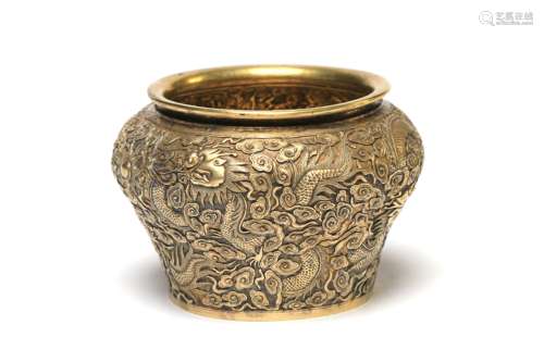 A small silver gilt spittoon decorated with dragons writhing...