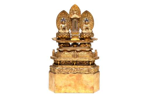 A wooden Buddha seated on lotus base