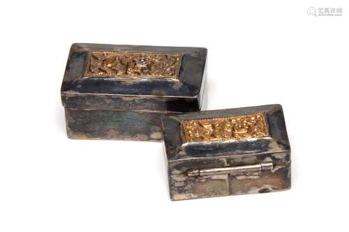 Two carved and repousse' silver boxes in the shaped of ...