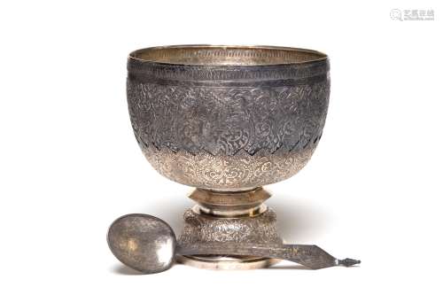 A set of carved and repousse' silver bowl and ladle dec...