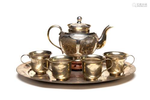 A gilt metal (silver) tea serving set decorated with birds a...