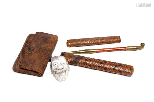 A Japanese pipe with leather tobacco bag with neisuke