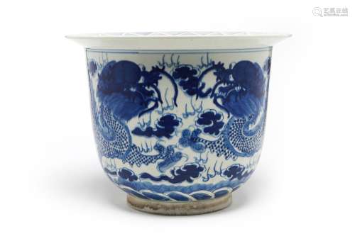 A blue and white porcelain planter painted with dragons writ...