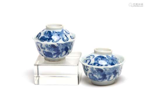 A pair of blue and white porcelain miniature teacups painted...