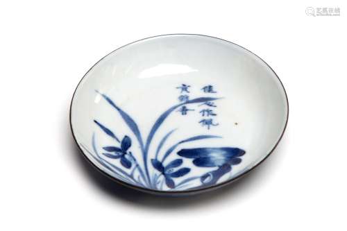 A blue and white porcelain saucer painted to exterior with d...