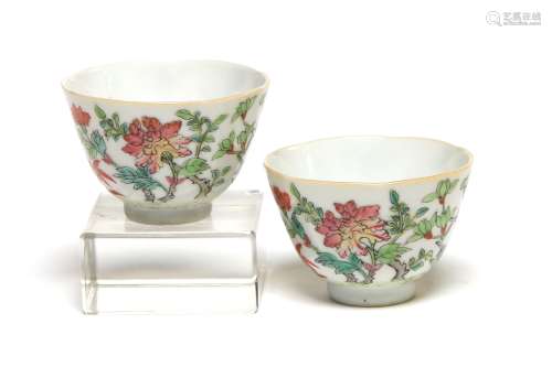 A pair of polychrome porcelain teacups painted with flower o...
