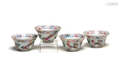 Four polychrome porcelain teacups painted with birds among p...