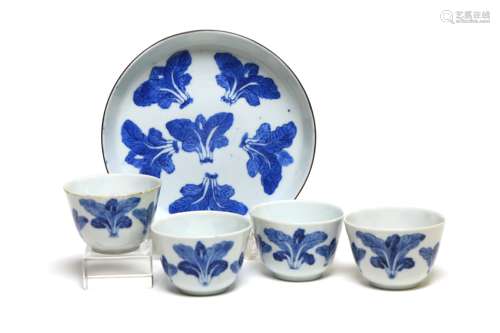 A blue and white porcelain tea set comprising four teacups a...