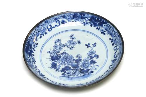A blue and white porcelain export dish painted with plum and...