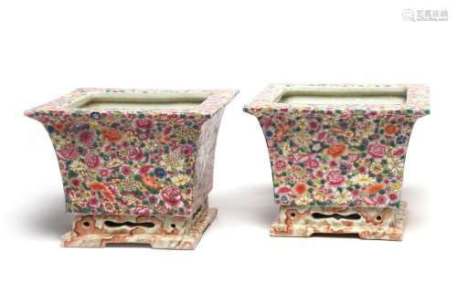 A pair of polychrome porcelain planters, each painted with b...