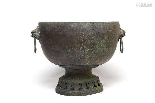 A bronze ceremonial ritual bowl with lion-mask and loose rin...