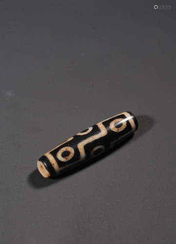 A NINE-EYED DZI BEAD