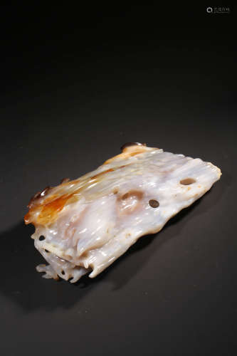A CARVED AGATE SCROLL WEIGHT