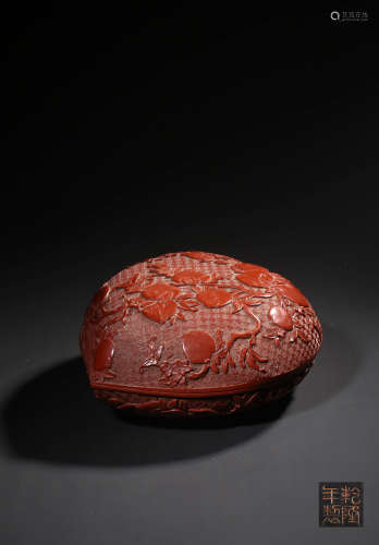 A CARVED CINNABAR LACQUER PEACH-SHAPED BOX AND COVER,MARK AN...