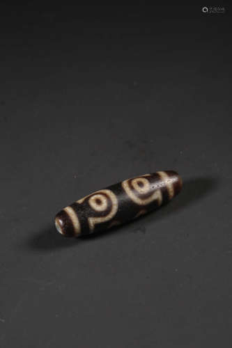 A SEVEN-EYED DZI BEAD