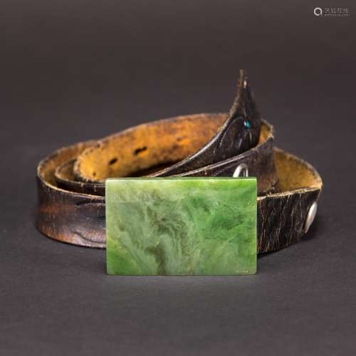 A GREEN JADE BELT BUCKLE STAMPED LEATHER BELT