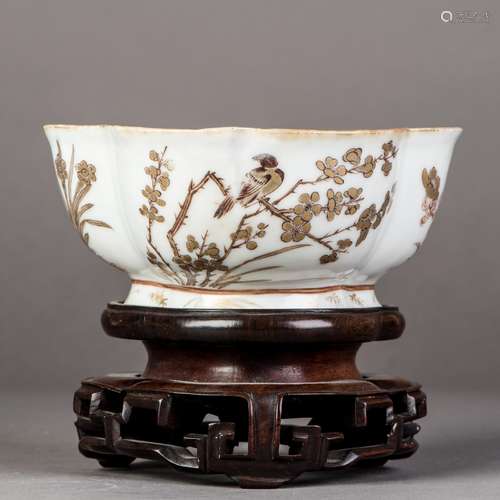 A GILT FLORAL AND BIRD MOTIF BOWL WITH HARDWOOD BASE