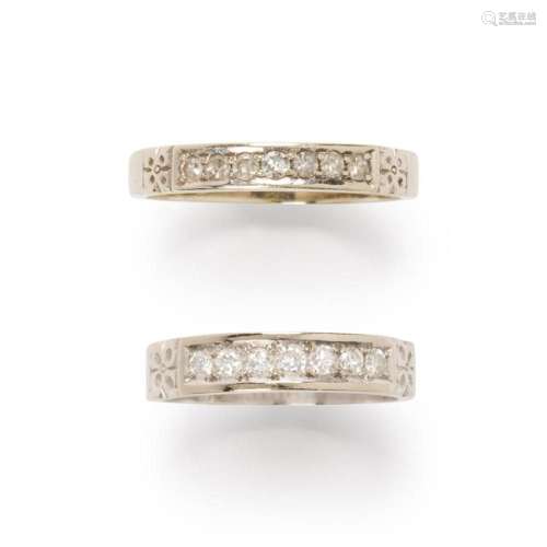 A pair of diamond and fourteen karat white gold rings
