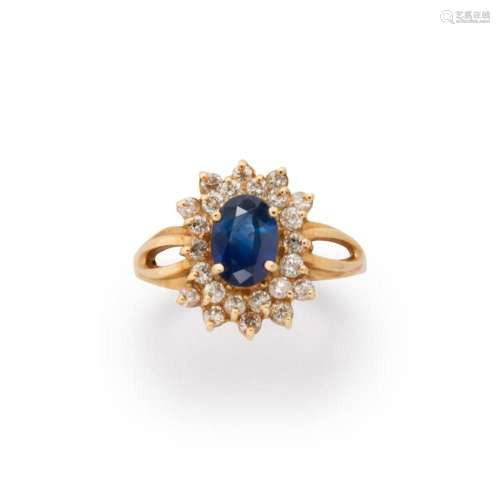 A sapphire, diamond and fourteen karat gold ring