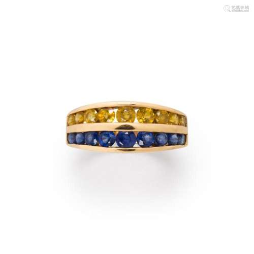 A yellow or blue sapphire and fourteen karat gold ring
