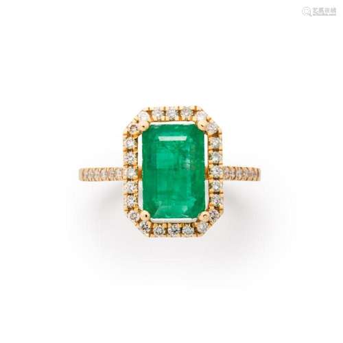 An emerald, diamond and fourteen karat gold ring