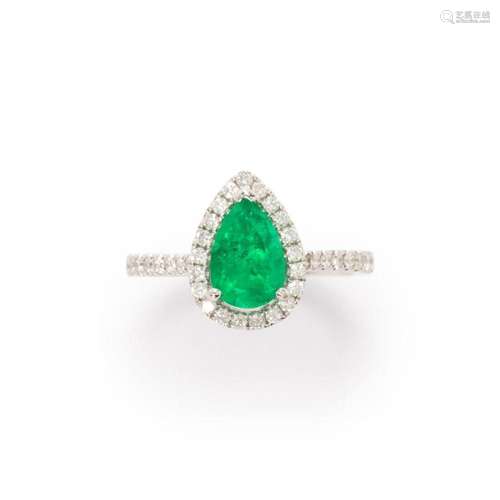 An emerald, diamond and fourteen karat white gold ring