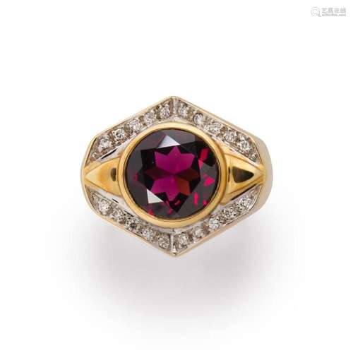 A garnet, diamond and fourteen karat bi-color gold ring