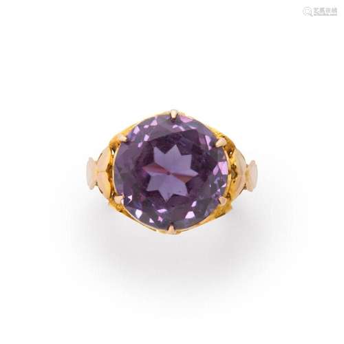 A synthetic color-changing sapphire and fourteen karat gold ...