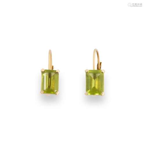 A pair of peridot and fourteen karat gold earring