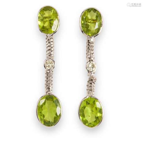 A pair of peridot, diamond and fourteen karat white gold ear...