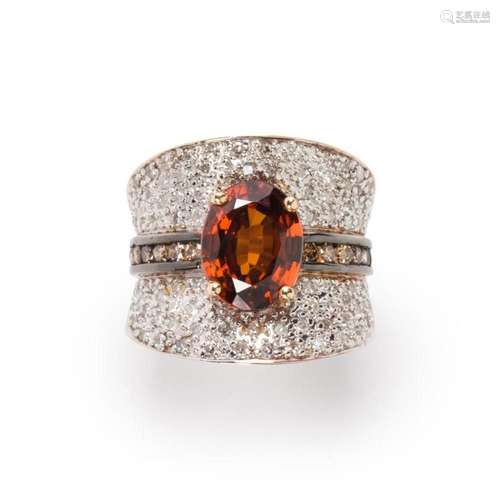 A brownish orange sapphire, diamond and fourteen karat bi-co...