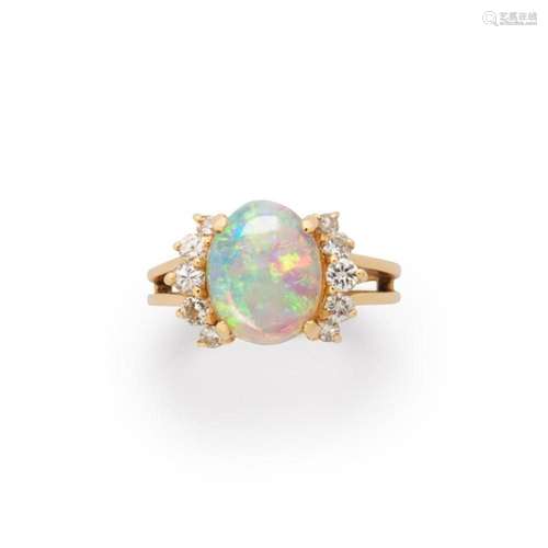 An opal, diamond and fourteen karat gold ring