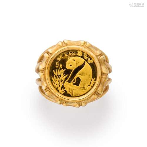 A gold coin and ten karat gold ring