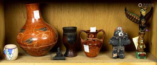 One shelf of mostly pottery including a small vase signed Te...