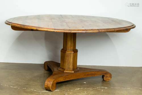 Provincial style pine pedestal table, having a circular top,...