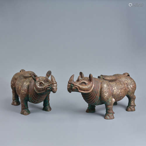 A pair of silver-inlaid bronze large rhinoceroses-form vesse...