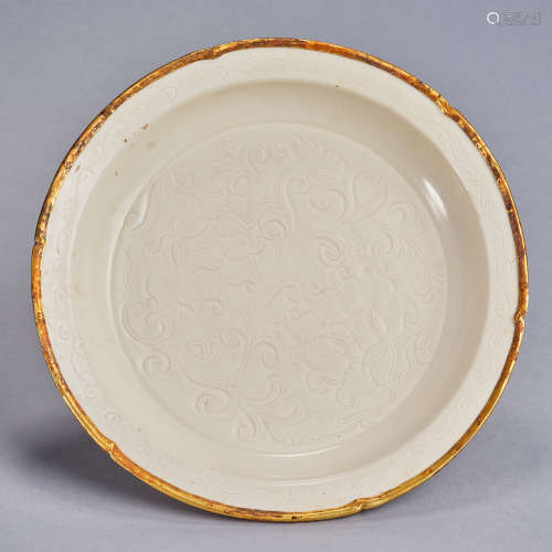 A carved Dingyao 'floral' plate, Song dynasty