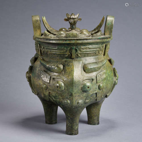 A tripod bronze ritual food vessel 'Ding' with 'oxes'cover,W...