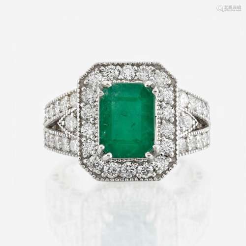 An emerald, diamond, and white gold ring