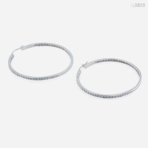 A pair of 14K white gold and diamond hoop earrings