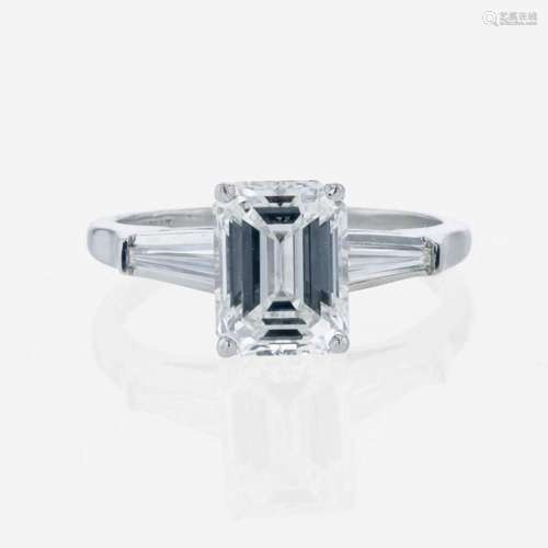 An emerald-cut diamond accented solitaire ring