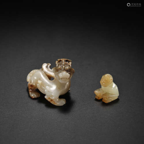 A GROUP OF CHINESE HAN DYNASTY HETIAN JADE ORNAMENTS