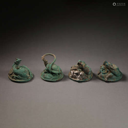 A GROUP OF BRONZE PAPERWEIGHTS, WARRING STATES PERIOD OR HAN...