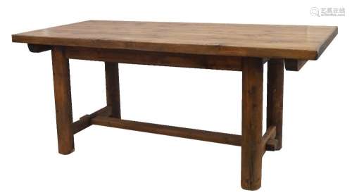 A modern pine refectory table, the plank top raised on cylin...