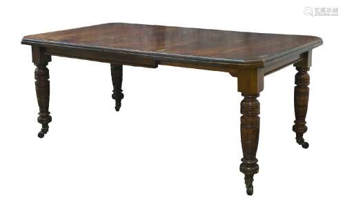 A late Victorian mahogany wind out dining table, with one ex...
