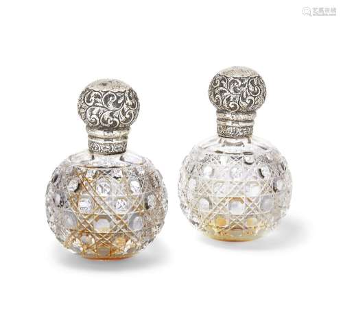 A pair of silver mounted glass perfume bottles, London, 1900...