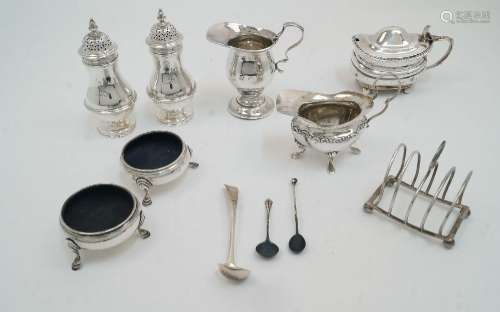 A group of silver comprising: two cream jugs, (one with circ...