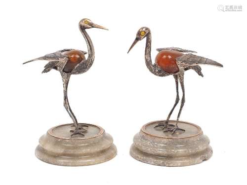 A pair of white metal and hardstone models of storks, both s...